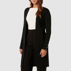 Model wearing Forever New Daphne Ribbed Cardigan in black, open-front longline style with pearl-button cuff detail
