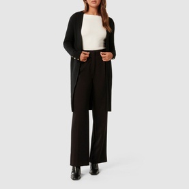 Model wearing Forever New Daphne Ribbed Cardigan in black, open-front longline style, styled with white top and black wide-leg trousers