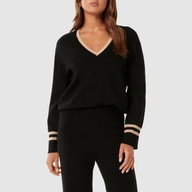 Model wearing Forever New Hattie Knit Sweater in black with V-neckline and gold contrast stripe trims at cuffs and neckline