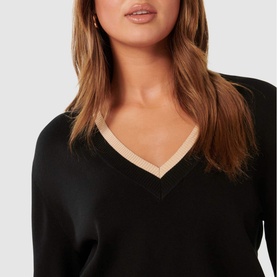 Model wearing Forever New Hattie Knit Sweater in black with contrast beige V-neckline trim, close-up detail shot
