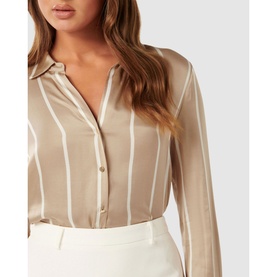 Model wearing Forever New Harvey Striped Shirt in beige with white stripes, collared neckline and button fastening, styled with white trousers