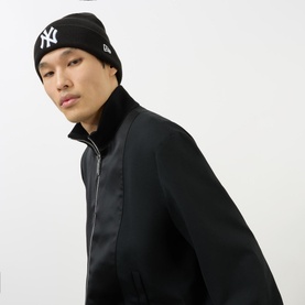 Model with New Era New York Yankees Beanie Hat in black, rib-knit turn-up style with embroidered NY logo, styled with black zip-up jacket