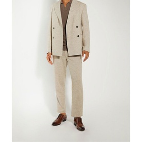 Model wearing a beige double-breasted linen suit and brown turtleneck, with Dune Southwark Smart Lace-Up Shoes in brown leather