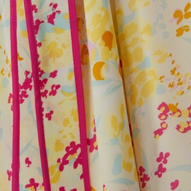 Reiss Lyla Floral Mini Skirt in pink, close-up of floral print fabric with yellow and blue blooms and contrast pink stripe trims