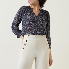 Model wearing Part Two Elsia Floral Relaxed Fit Blouse in navy with white floral print, styled with cream wide-leg trousers