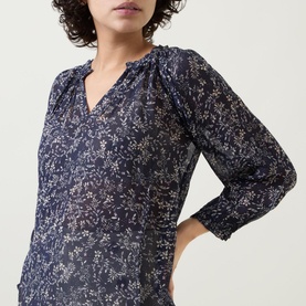 Model wearing Part Two Elsia Floral Relaxed Fit Blouse in navy with delicate floral print, open placket neckline and cropped sleeves with flared