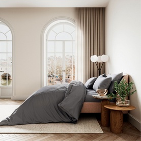 Belfast Fine Linens Cotton Sateen Fitted Sheet in Charcoal, styled on a bed with matching pillowcases in a bright, elegant bedroom setting