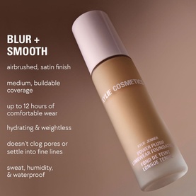 KYLIE BY KYLIE JENNER Power Plush Longwear Foundation in warm beige shade, glass bottle with lilac cap, shown with blur and smooth finish claims