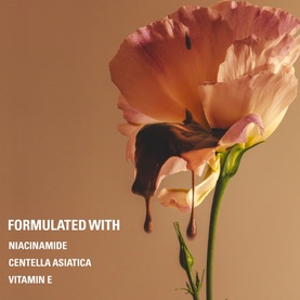 KYLIE BY KYLIE JENNER Power Plush Longwear Foundation campaign image with pink flower, formulated with Niacinamide, Centella Asiatica, Vitamin E