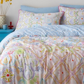 Appletree Casablanca Duvet Set Multi, cotton bedding with multicolour floral and geometric print on pale blue background, styled on bed