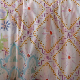 Appletree Casablanca Duvet Set Multi, close-up of diamond trellis pattern with floral motifs in pastel purple, teal, and gold on white cotton