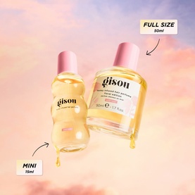 GISOU Honey Infused Hair Perfume Floral Edition Wild Rose shown in mini 15ml and full size 50ml bottles against a soft pink sky backdrop