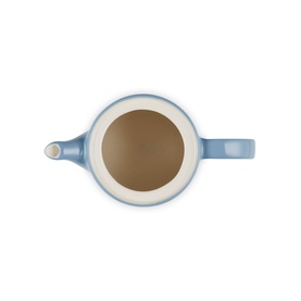 Le Creuset Stoneware Grand Teapot 1.3L in blue, overhead view showing cream interior and handle detail