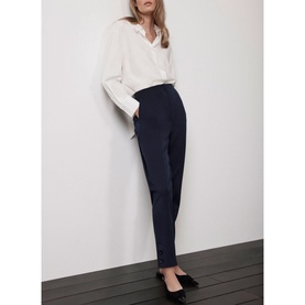 Model wearing Mint Velvet Blue Slim-Leg Tailored Trousers, ankle grazer length, styled with a white shirt and black heels