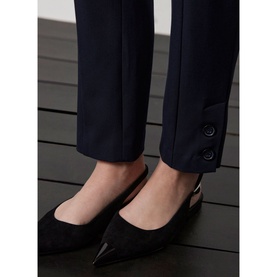 Model wearing Mint Velvet Blue Slim-Leg Tailored Trousers, ankle grazer length with split hems and double button detail