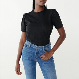 Model wearing Twist & Tango Isa Regular Fit T-Shirt in black with round neck and short puff sleeves, styled with blue jeans
