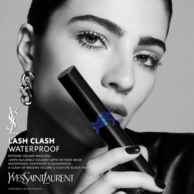 Model with YSL Lash Clash Waterproof Mascara, showcasing bold volumised lashes, holding the black mascara tube