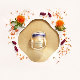 Shiseido Vital Perfection Concentrated Supreme Cream Jar & Refill Duo skincare set, surrounded by orange and red dried botanicals on a wooden dish