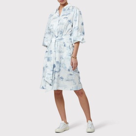 Model wearing Helen McAlinden Odette Toile de Jouy Shirt Dress in blue with tie waist, styled with white trainers