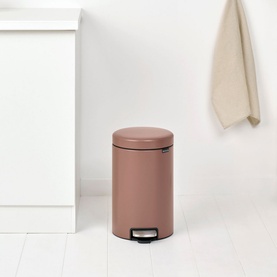 Brabantia NewIcon Pedal Bin 12L in Taupe, rounded steel design with foot pedal, styled in a clean bathroom setting