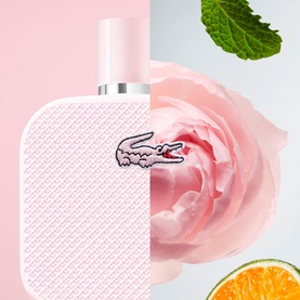 Lacoste L12.12 Rose Eau de Parfum 100ml pink bottle styled with a rose bloom, mint leaves, and citrus fruit slices