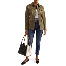 Model wearing Hobbs Farrah Button-Down Jacket in green with stripe top, dark jeans, black flats, carrying a tan tote bag
