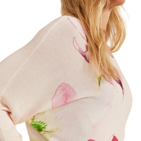Model wearing Phase Eight Erika Placement Floral Sweater in multi, close-up showing pink floral print on pale pink knit with batwing sleeve detail