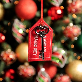 Festive Productions Santa's Magic Key Tree Decoration, red felt gift tag with printed text and ornate metal key charm, hanging on Christmas tree