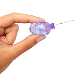 LOL Surprise Water Balloon Tots Doll in iridescent purple, shown held between fingers being filled with water via small nozzle