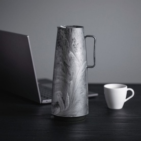 Tramontina Grey Thermal Flask with marbled swirl pattern and ergonomic handle, styled on a dark desk beside a laptop and white espresso cup