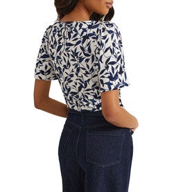 Model wearing Phase Eight Nayana Leaf Print Blouse in blue, rear view, showing flutter sleeves and all-over leaf print