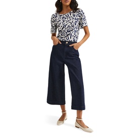 Model wearing Phase Eight Nayana Leaf Print Blouse in blue with wide-leg navy cropped trousers and nude ballet flats