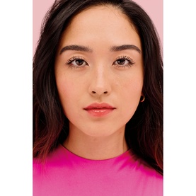 Model with Benefit Splashtint Moisturising Dewy Lip Tint, wearing a soft pink-nude shade with defined lashes and glowing skin