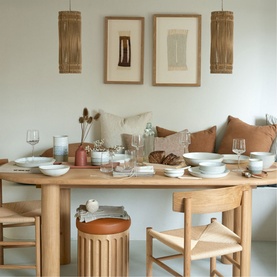 Denby Kiln Straight Teapot in beige stoneware, styled on a oak dining table with bowls, glasses and terracotta cushions in background