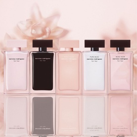 Narciso Rodriguez Musc Nude for Her EDP among five For Her fragrance bottles in pink and black, displayed on reflective surface with floral backdrop