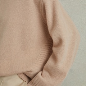 Model wearing Reiss Elena Marled-Knit Sweater in pink, wool-cashmere blend with ribbed trims and dropped shoulders, styled with cream trousers
