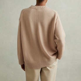 Model wearing Reiss Elena Marled-Knit Sweater in pink, showing rear view with seam detailing, dropped shoulders and ribbed hem