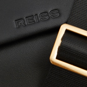 Reiss Selena Logo Crossbody Bag in black grained leather with embossed logo and gold-tone square buckle hardware detail