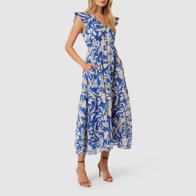 Model wearing Forever New Florence Floral Dress in blue floral print with V-neckline, frill sleeves and tiered skirt, styled with nude heeled sandals