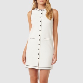 Model wearing Forever New Molly Tipped Mini Dress in white with contrast black tipping, button placket, round neckline, and welt pockets