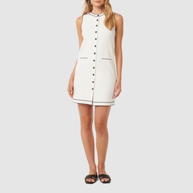 Model wearing Forever New Molly Tipped Mini Dress in white with black contrast tipping, button placket, round neckline and welt pockets