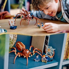 Lego Aragog in the Forbidden Forest set with posable spider figure, two minifigures, and web build; child playing with set on table