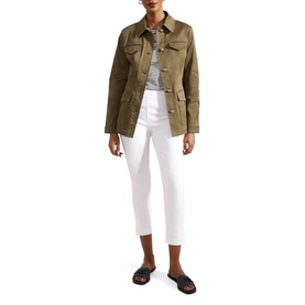 Model wearing Hobbs Giselle Mid-Rise Capri Trousers in white, slim tapered leg with split hem, styled with olive utility jacket and black sandals