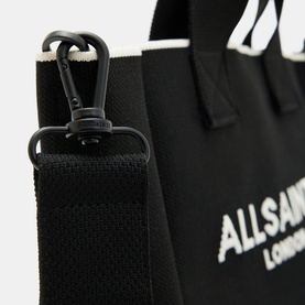 All Saints Izzy Knitted Mini Tote Bag in black, close-up showing detachable black clip strap and jacquard logo detail