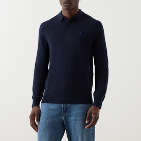 Model wearing Ralph Lauren Knitted Logo Long-Sleeved Polo Shirt in navy wool with embroidered logo, styled with light blue jeans