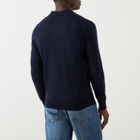 Model wearing Ralph Lauren Knitted Logo Long-Sleeved Polo Shirt in navy wool, rear view, styled with light-wash jeans