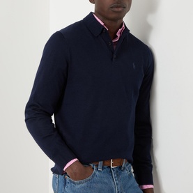 Model wearing Ralph Lauren Knitted Logo Long-Sleeved Polo Shirt in navy wool, styled with pink shirt and blue jeans