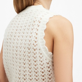 Model wearing All Saints Vivian Open-Stitch Knitted Vest in white, showing open-stitch detail and scalloped-edge trim at back