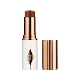 Charlotte Tilbury Superstar Glow Blush Stick in deep brown-bronze shade, white and rose gold packaging with lid placed beside