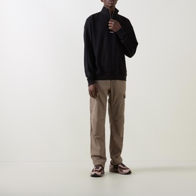 Model wearing Hugo Logo Half-Zip Sweatshirt in black with beige cargo trousers and brown chunky trainers